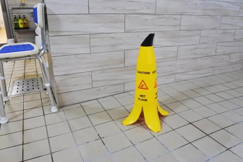a yellow caution cone sitting on a kitchen floor at Hotel La'gent Plaza Hakodate Hokuto in Hokuto