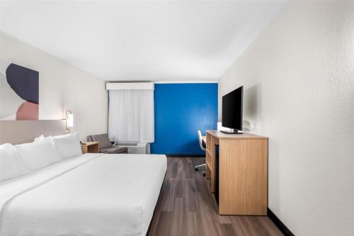 a hotel room with a bed and a tv at Spark by Hilton Roanoke Civic Center in Roanoke