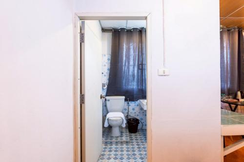 a bathroom with a white toilet in a room at X At Gate Suvarnabhumi Airport in Ban Khlong Prawet