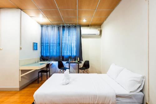 a room with a bed and a desk and a window at XX At Gate Suvarnabhumi Airport in Lat Krabang