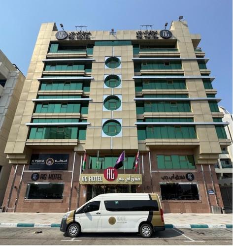a white van parked in front of a building at AG Hotel in Abu Dhabi