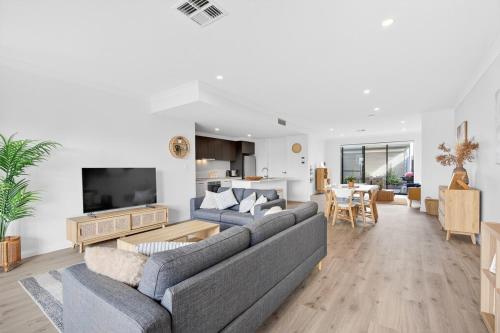 a living room with a couch and a table at Waterside in Victor Harbor