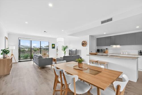 a kitchen and living room with a table and chairs at Waterside in Victor Harbor