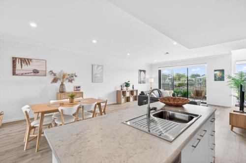 a kitchen and living room with a table and chairs at Waterside in Victor Harbor