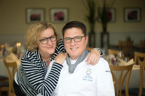 a woman hugging a man wearing glasses at Gasthaus zum Bahnhof in Berg