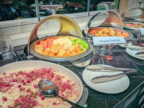 a buffet of different types of food on a table at Petra Bermudez Hotel in Wadi Musa