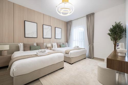 a hotel room with two beds and a couch at DVH Luxe Retreats 2BR Yas Island by Ferrari World & Yas Mall in Abu Dhabi