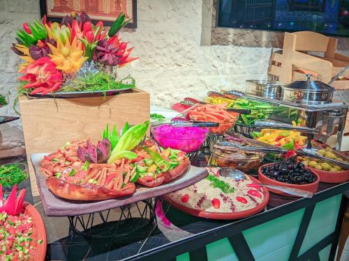a buffet filled with lots of different types of food at Petra Bermudez Hotel in Wadi Musa