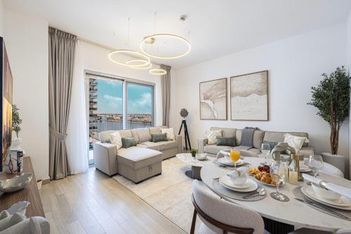 a living room with a table and a couch at DVH Luxe Retreats 2BR Yas Island by Ferrari World & Yas Mall in Abu Dhabi