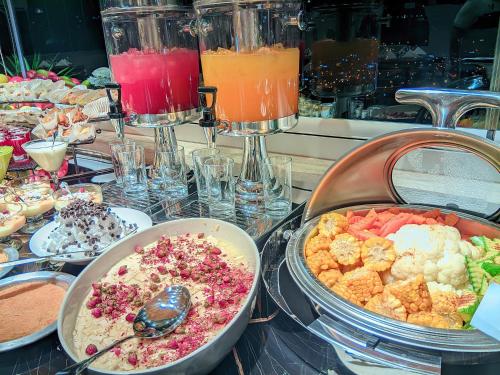a buffet with many different types of food and drinks at Petra Bermudez Hotel in Wadi Musa