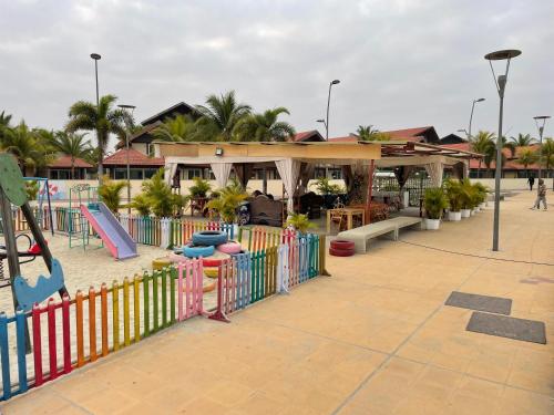 a playground with a slide and a fence at Comfort zone in Futungo de Belas