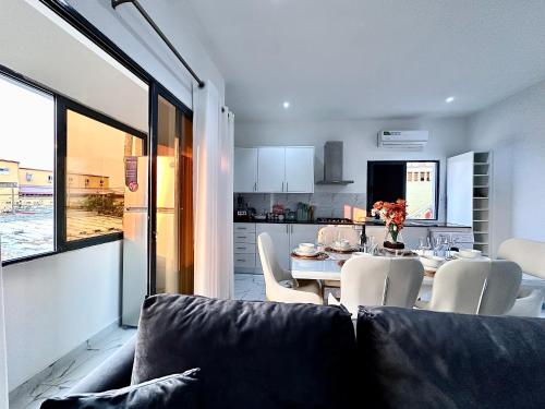 a living room with a couch and a table with chairs at Comfort zone in Futungo de Belas