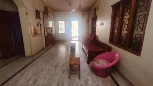a living room with a couch and a pink tub at Sri Hari nilayam home stay in Tirupati