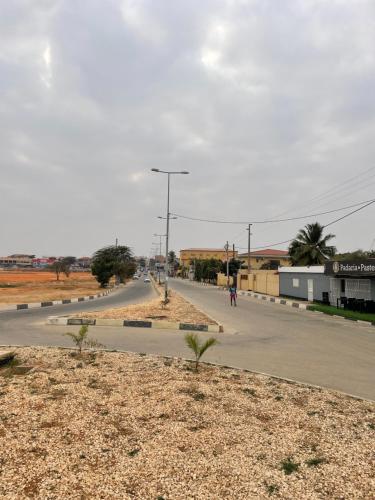 an empty road in the middle of a town at Comfort zone in Futungo de Belas