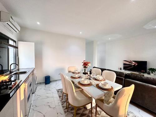 a kitchen and dining room with a table and chairs at Comfort zone in Futungo de Belas