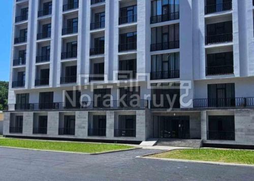 a large white building with a lot of windows at New Alvina in Tsaghkadzor
