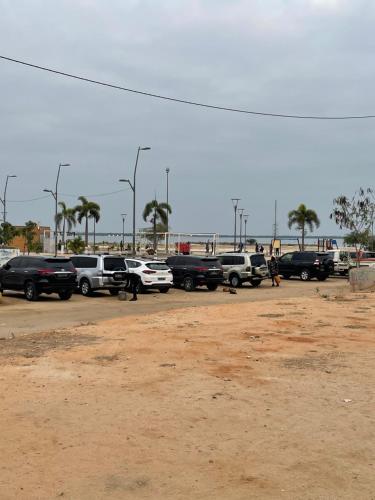 a parking lot with a bunch of parked cars at Comfort zone in Futungo de Belas
