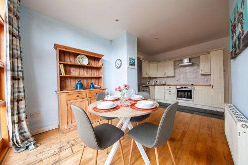a kitchen and dining room with a table and chairs at Light Filled 2BD Home with Sea Views Baldoyle in Baldoyle
