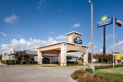 aldrin gas station with a sign in front of it at Days Inn & Suites by Wyndham Corpus Christi Central in Corpus Christi