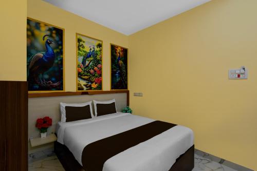 a bedroom with a bed and paintings on the walls at S S B Grand in Ibrāhīmpatan