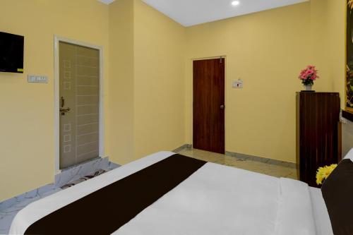 a bedroom with a bed and a door at S S B Grand in Ibrāhīmpatan