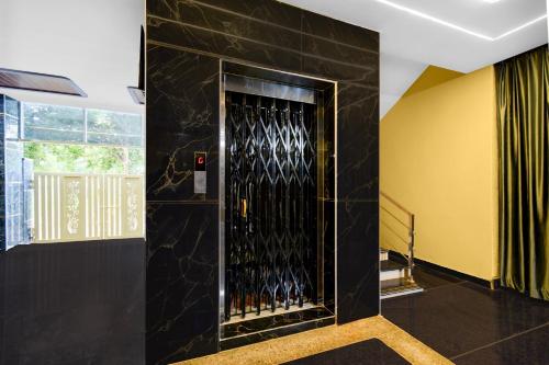 a black wall with a door with wine bottles at S S B Grand in Ibrāhīmpatan