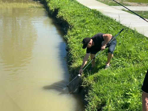 a man standing in the grass near a body of water at В тиші Келечина in Kelechin