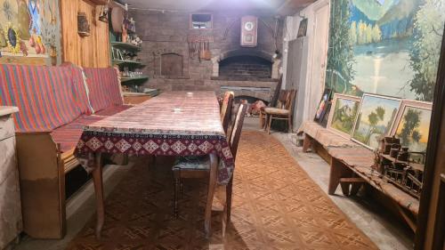 a dining room with a table and a fireplace at Nina B&B in Dilijan