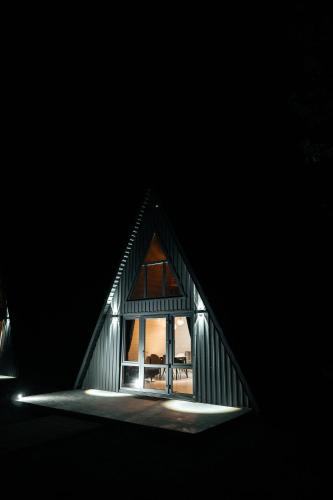 a small house with a window in the dark at В тиші Келечина in Kelechin