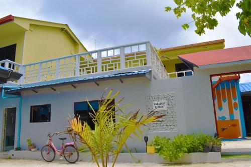 a pink bike parked in front of a house at Paradise Retreat, Maafushi in Maafushi
