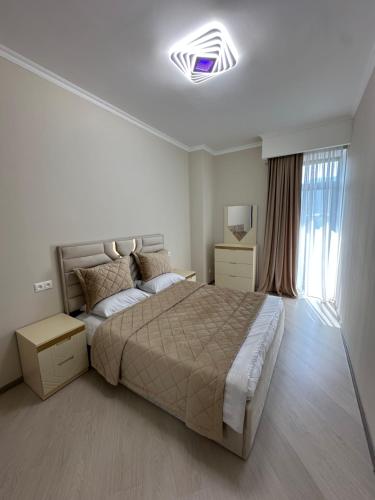 a bedroom with a large bed and a large window at Alvina complex Vakas Tsakghadzor apartament in Tsaghkadzor