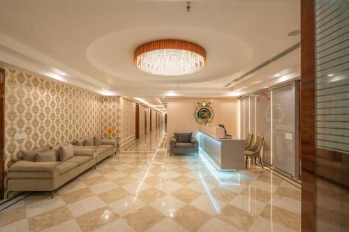 a lobby with a couch and a desk in a building at GAJRAULA SUKHDEV DHABA and RESORT 