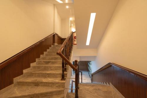 a staircase in a building with wooden floors and a skylight at GAJRAULA SUKHDEV DHABA and RESORT 