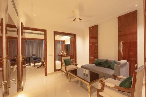 a living room with a couch and a table at GAJRAULA SUKHDEV DHABA and RESORT 