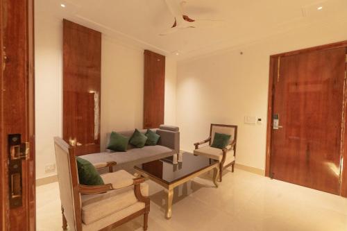 a living room with a couch and a table at GAJRAULA SUKHDEV DHABA and RESORT 
