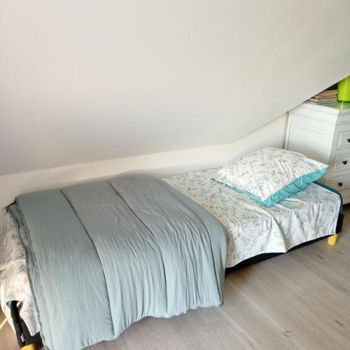 a small bed in a bedroom with a white dresser at Chambres chez particulier in Verneil-le-Chétif