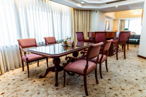 a conference room with a glass table and chairs at Horison Ultima Bandung in Bandung