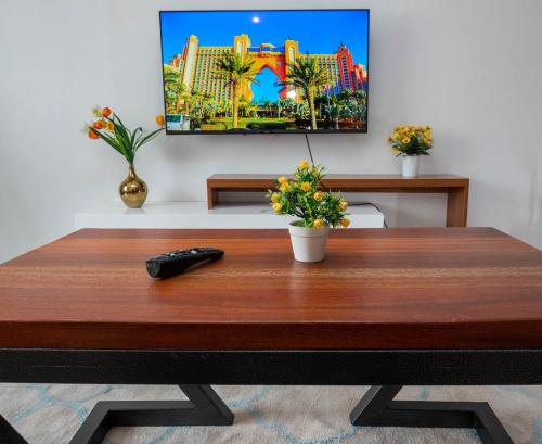 a wooden table with a remote control on top of it at Perfect Palm Condos-N12 in Nakuru
