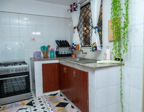 a kitchen with a sink and a stove at Perfect Palm Condos-N12 in Nakuru