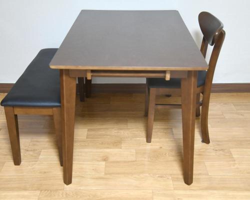 a table and two chairs with a table and a table and chairsuggest at Sorak Hostel in Sokcho