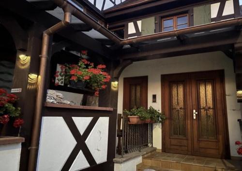 a front door of a house with potted plants at Heol - La bonne Étoile 