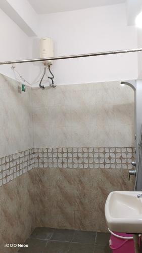 a bathroom with a sink and a toilet at Hitech Shilparamam Guest House in Hyderabad
