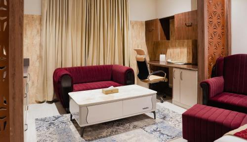 a living room with two chairs and a table at The Meriton in Jāmb