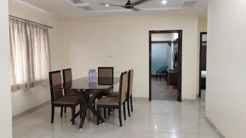a dining room with a table and chairs at Hitech Shilparamam Guest House in Hyderabad