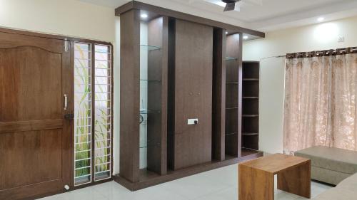 a living room with a sliding glass door at Hitech Shilparamam Guest House in Hyderabad