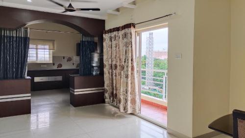 a living room with a large window with a view at Hitech Shilparamam Guest House in Hyderabad