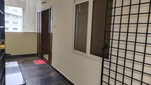 an empty room with a window and a floor at Hitech Shilparamam Guest House in Hyderabad