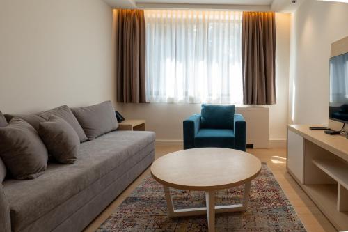 a living room with a couch and a table at Zepterme Spa&Wellness Luxury Apartments member of Zepter hotels in Vrnjačka Banja