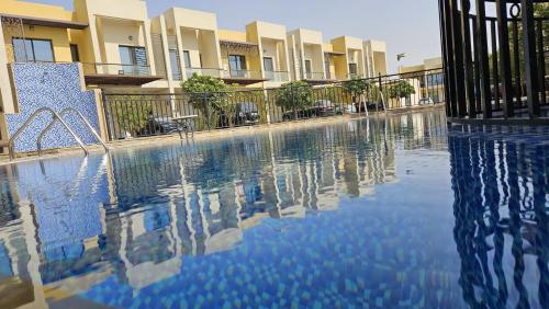 a swimming pool in front of a building at 3 Bhk Villa in Prime Location in Dubai