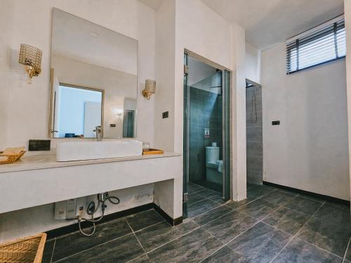 a bathroom with a sink and a mirror at De Chaochom Hua Hin in Hua Hin